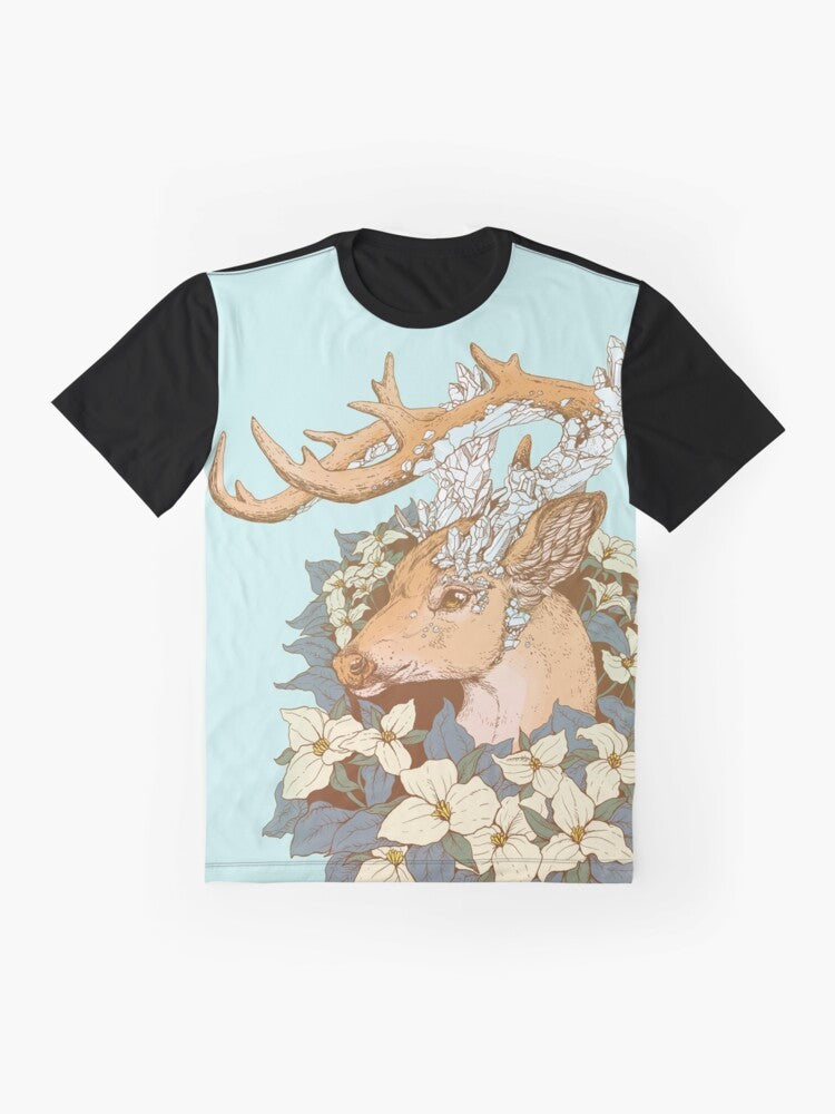 A graphic t-shirt featuring a non-typical blue quartz buck design with antlers and trillium flowers in a nature-inspired illustration. - Flat lay