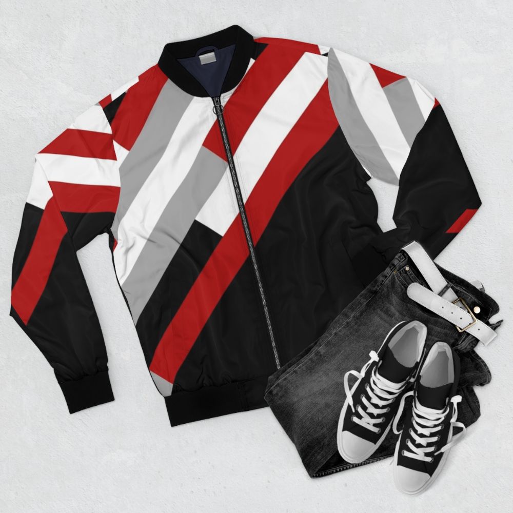 A minimalist bomber jacket with a diagonal stripes pattern in grey, red, and white colors. - Flat lay