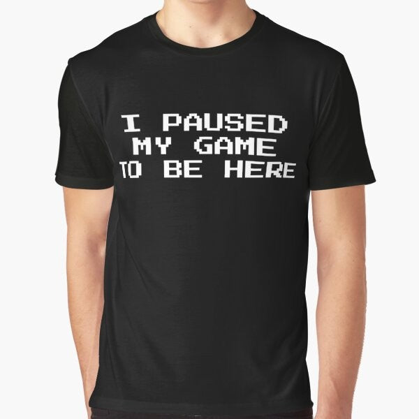 Graphic t-shirt with text "I Paused My Game to Be Here" for gamers and geeks.