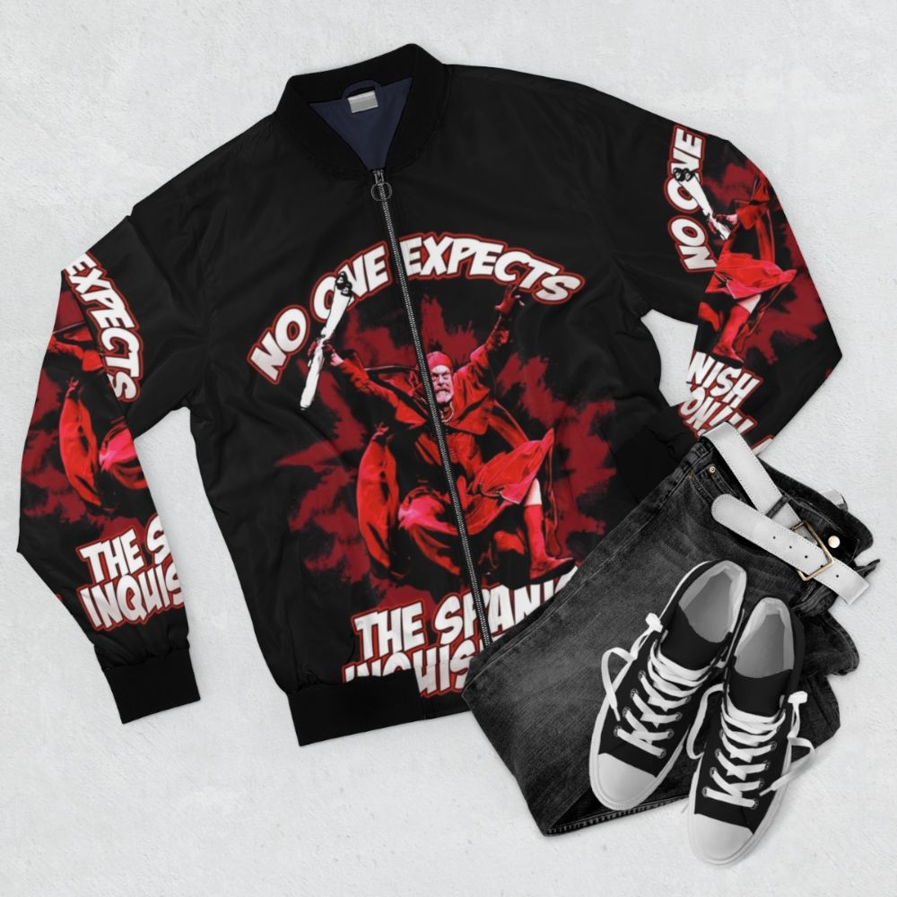 A bomber jacket featuring the famous "No one expects the Spanish Inquisition!" quote from Monty Python - Flat lay