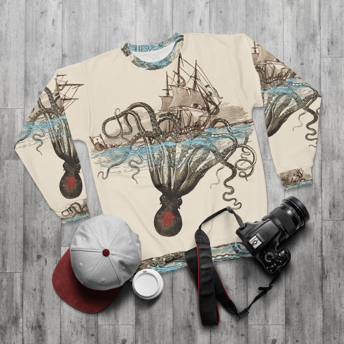 A person wearing a sweatshirt with a kraken design - flat lay