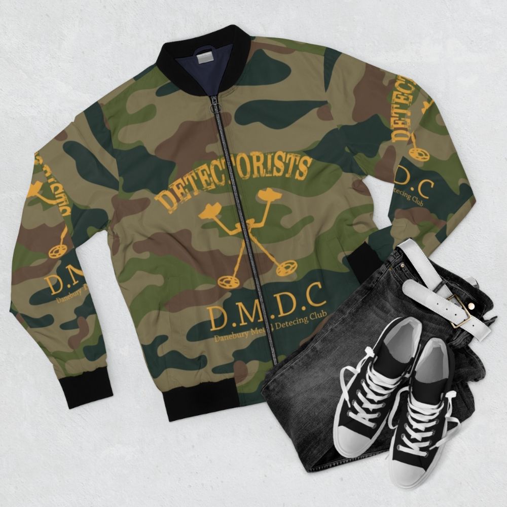 Detectorists Camo Bomber Jacket featuring the iconic Danebury Metal Detecting Club logo - Flat lay