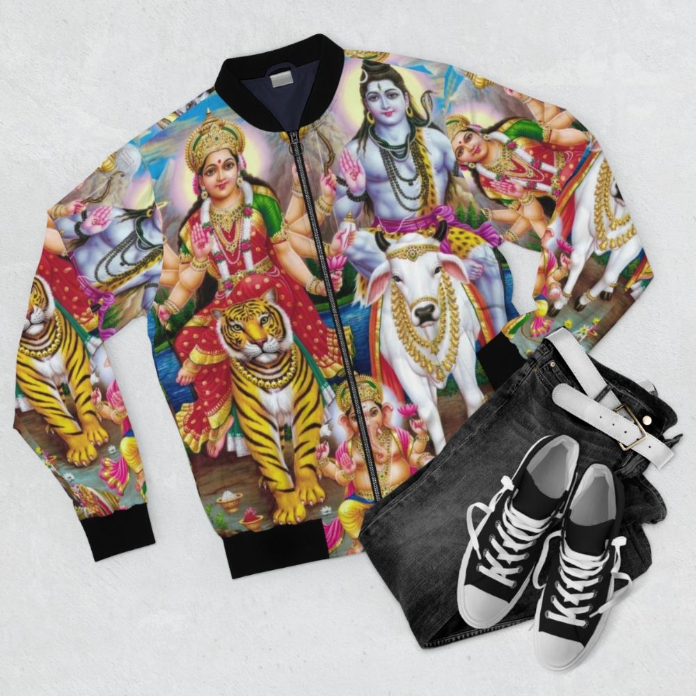 Hindu spiritual art featuring Shiva, Parvati, and Ganesha on a bomber jacket - Flat lay