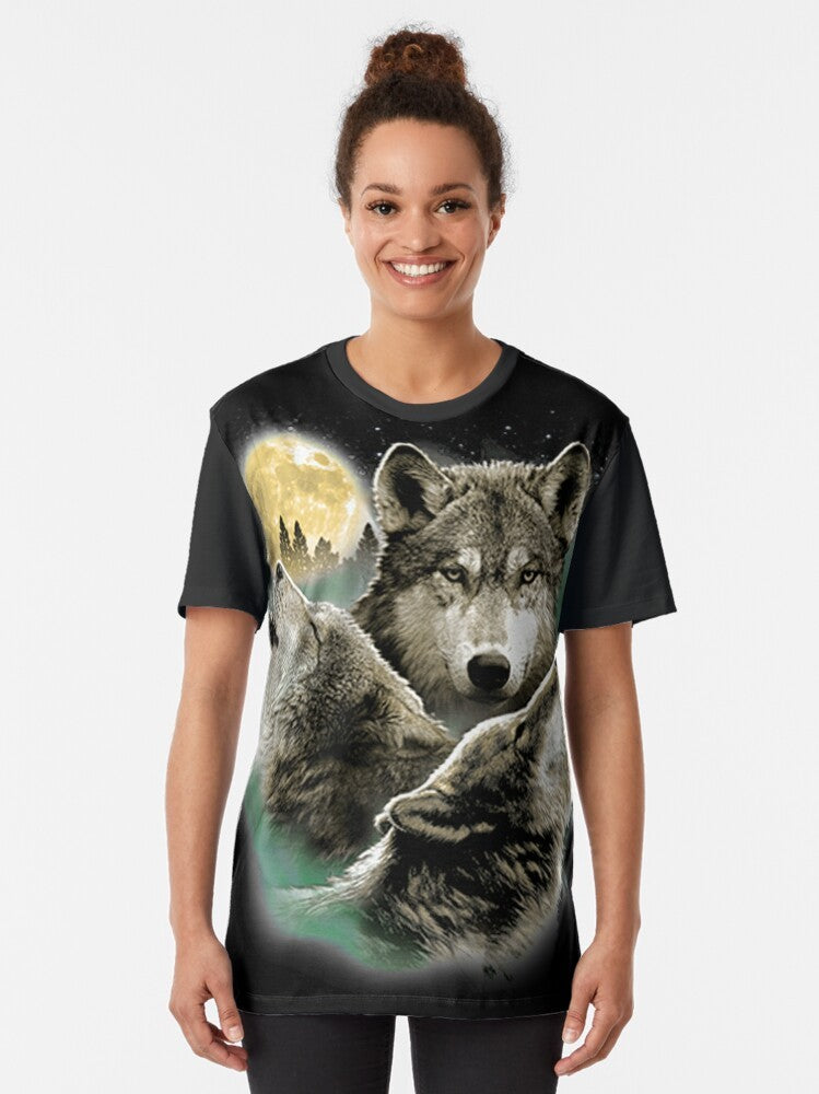 A graphic t-shirt design featuring three howling wolves against a full moon in the night sky. - Women