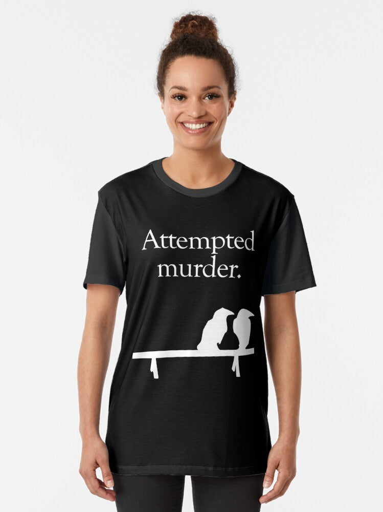 A graphic t-shirt design featuring the text "Attempted Murder" with stylized crows in black and white. - Women