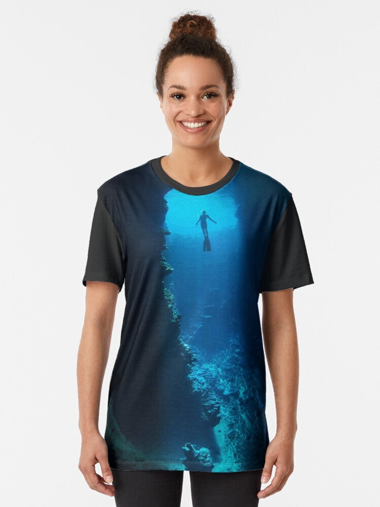 A graphic t-shirt featuring a free diver exploring the ocean - Women