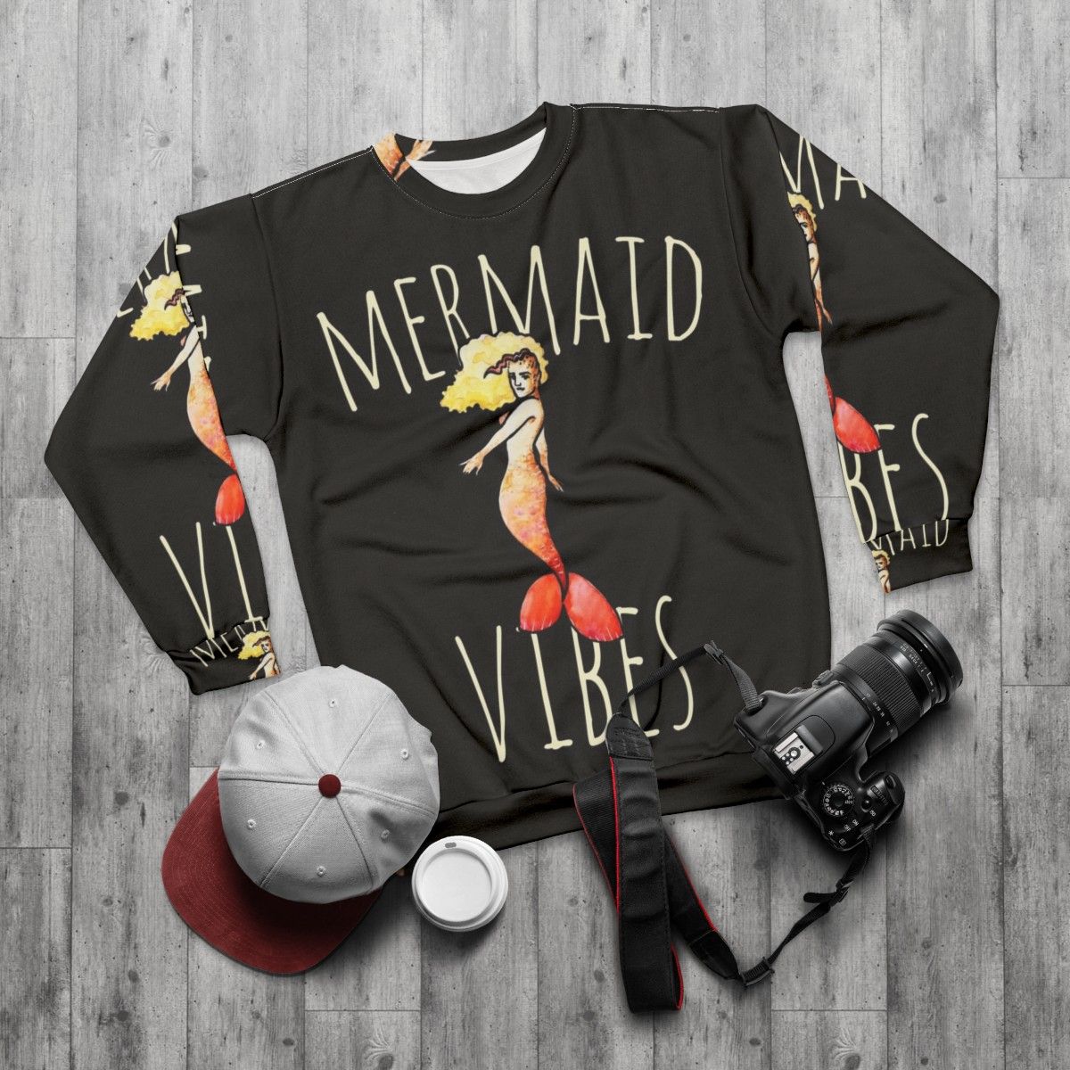 Mermaid-inspired sweatshirt with ocean-themed graphics - flat lay