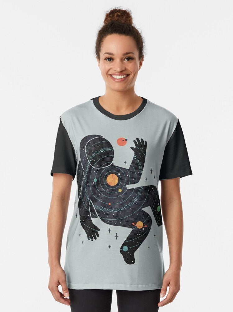 Graphic t-shirt design featuring a minimalist space and cosmos theme with an astronaut, planets, and the solar system. - Women