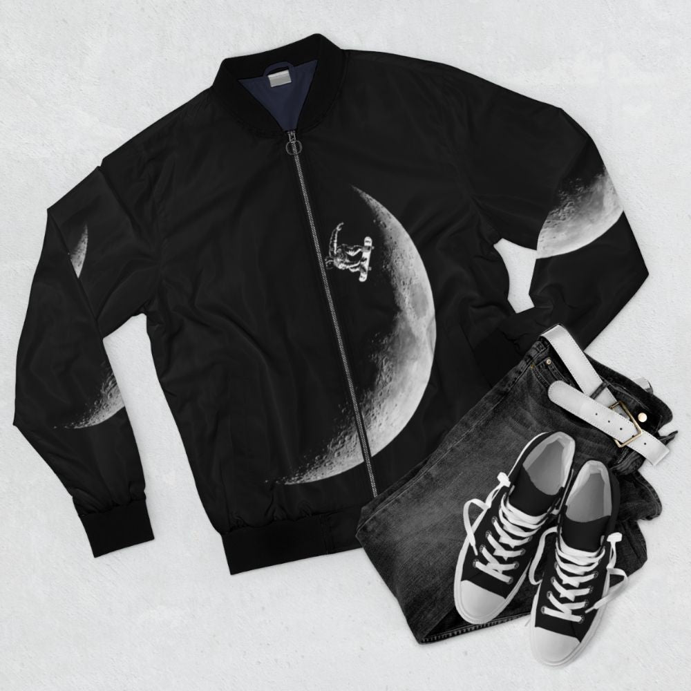 Astronaut skateboarding on the moon with a black and white bomber jacket - Flat lay