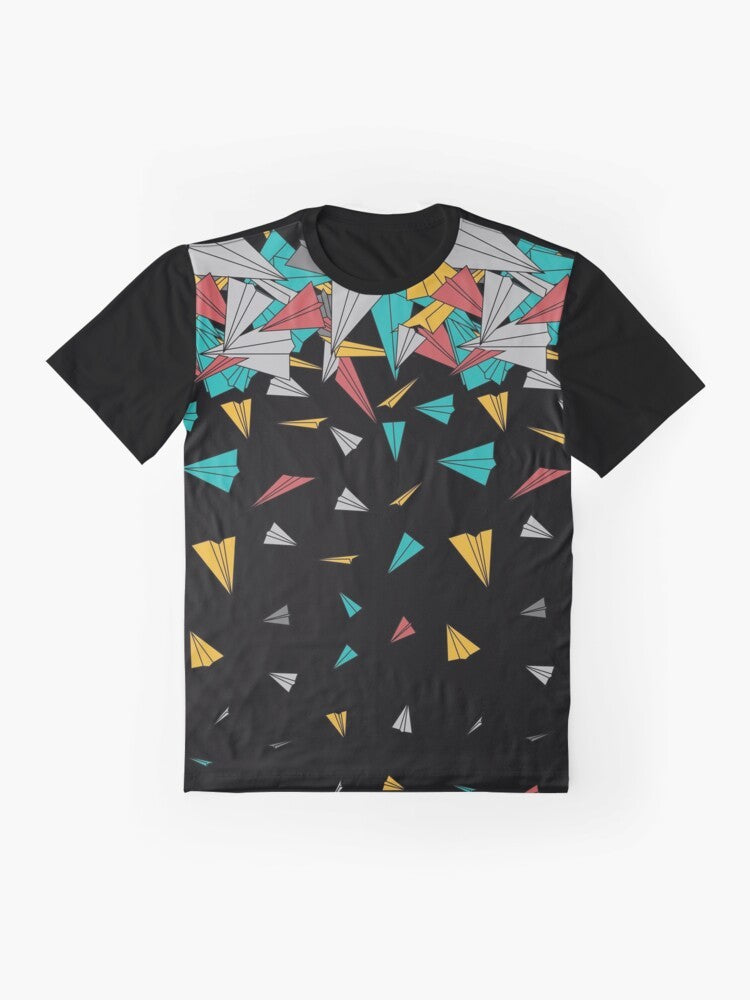 A colorful, abstract graphic t-shirt featuring a design of paper planes floating on a geometric pattern. - Flat lay