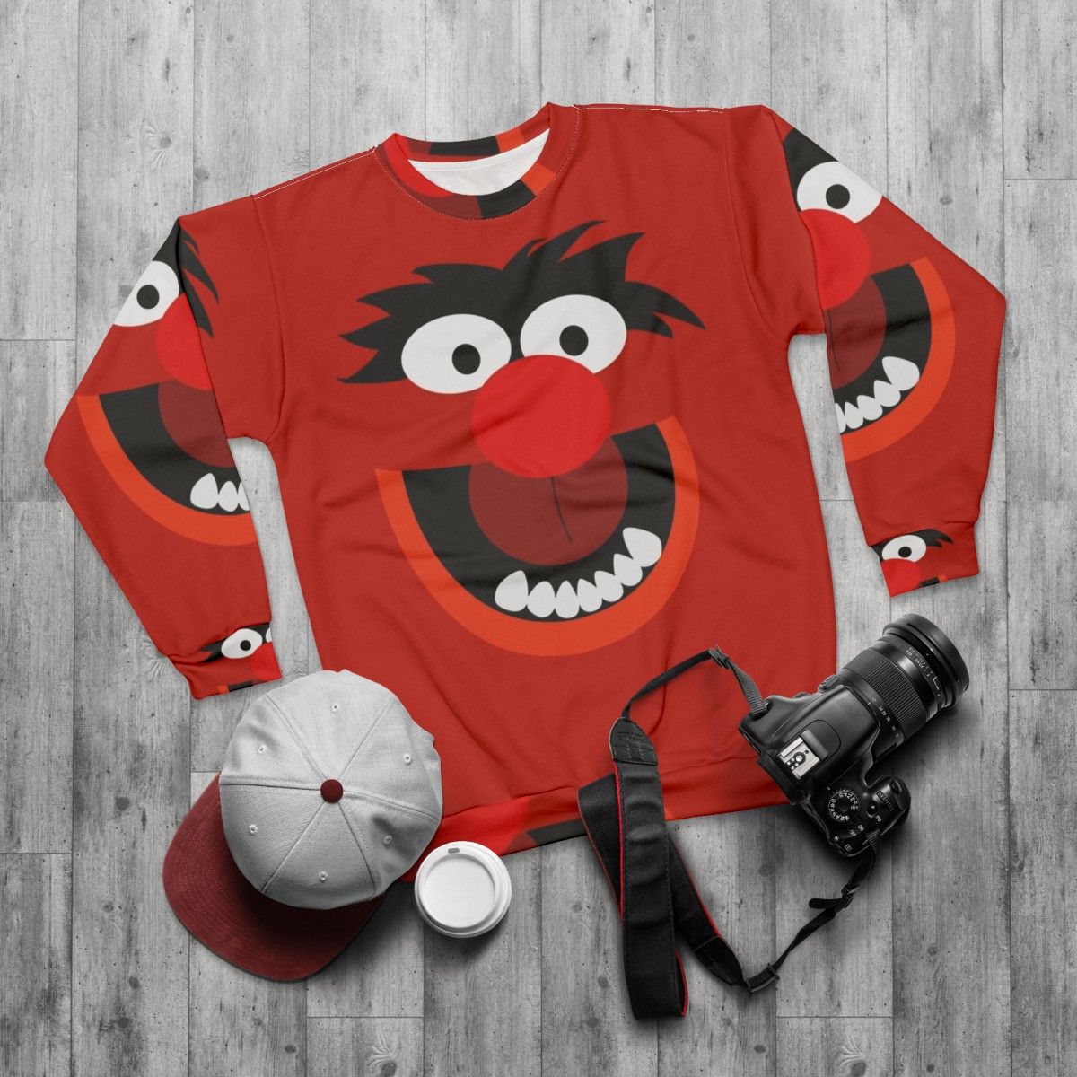 Colorful animal sweatshirt with muppets inspired cartoon creature design - flat lay