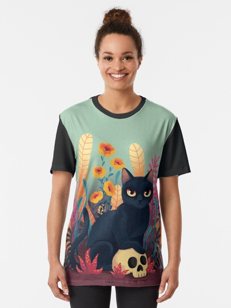 Cartoon image of a black cat with a skull and flowers on a graphic t-shirt design - Women