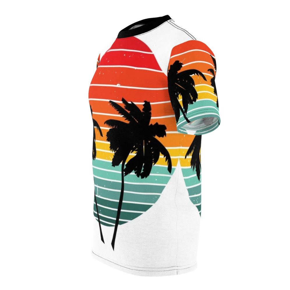 Person wearing a black t-shirt with a vivid tropical palm tree and sunrise silhouette design - men left