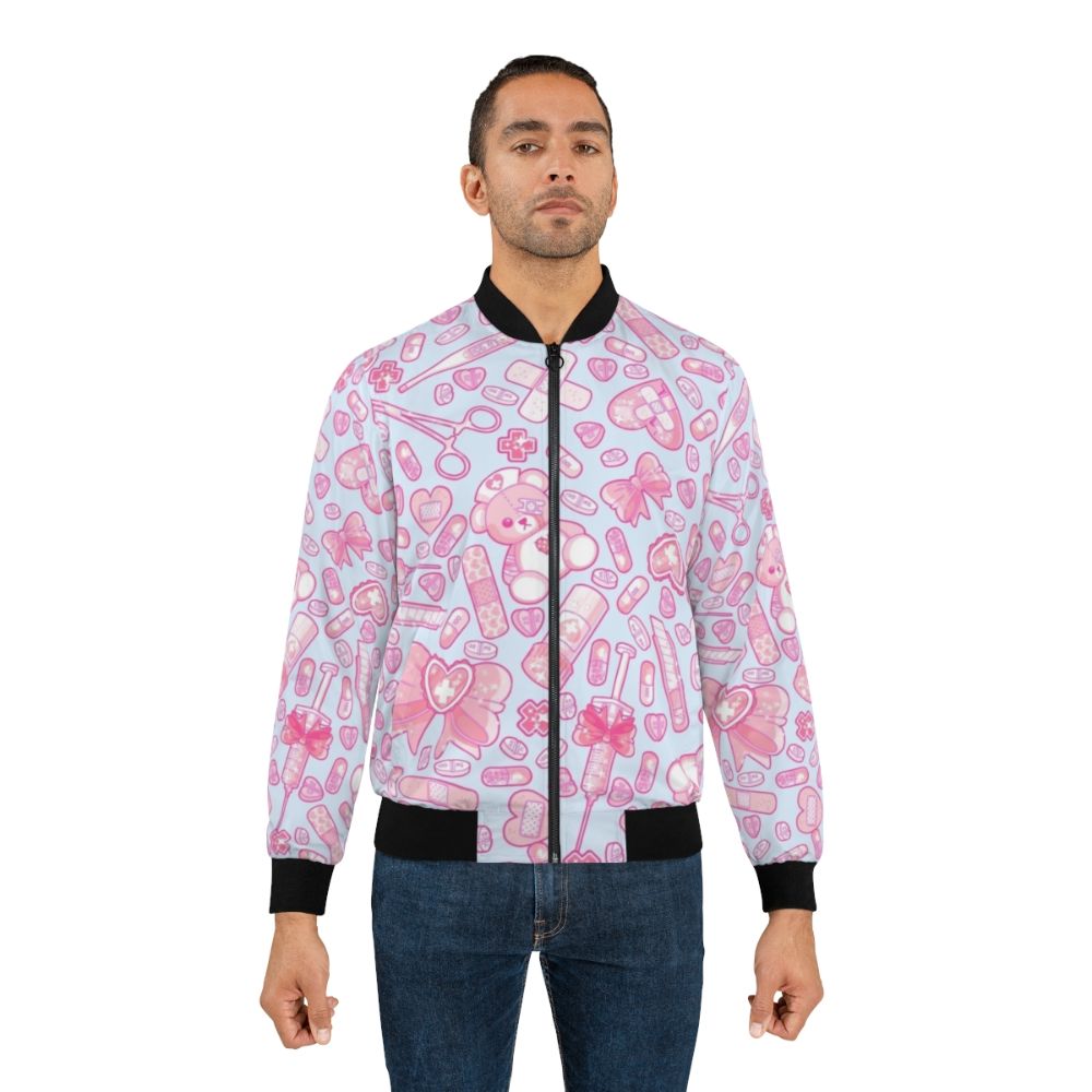 A pastel pink and white bomber jacket with a sickly sweet, creepy cute design featuring medical elements like pills and a hospital theme. - Lifestyle