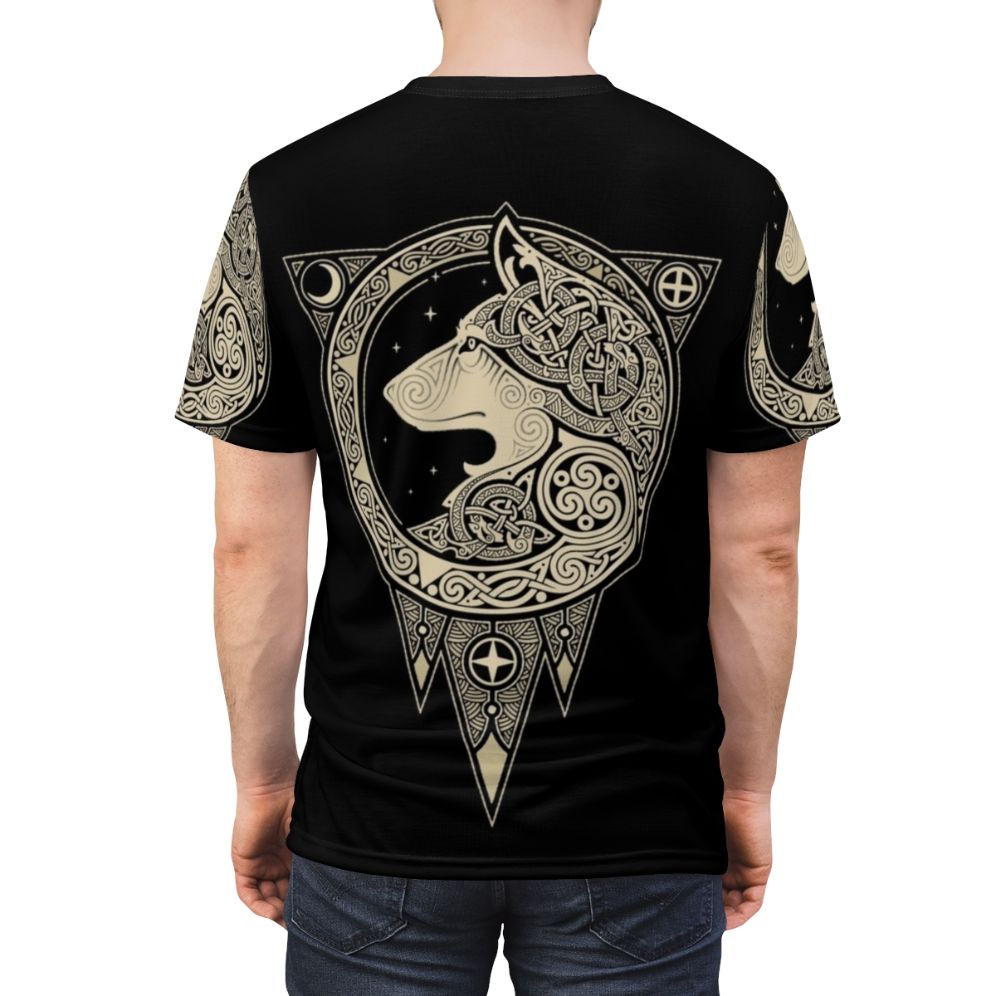 Photograph of a Norse-inspired t-shirt with a detailed wolf graphic, set against a background of celestial symbols and organic patterns. - men back