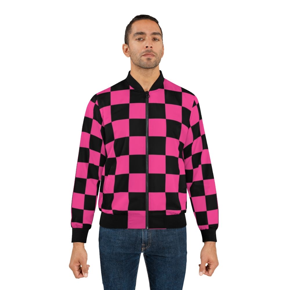 A stylish black and pink checkerboard pattern bomber jacket with a geometric design. - Lifestyle