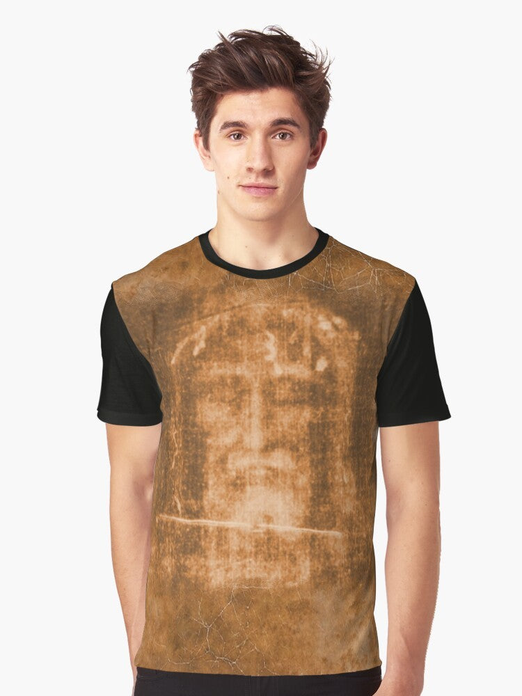 T-shirt featuring the Holy Face of Jesus and a crucifix, representing the passion and resurrection of Christ. - Men