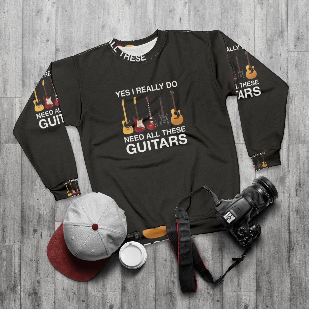 Person wearing a sweatshirt with the text "Yes I Really Do Need All These Guitars" - flat lay