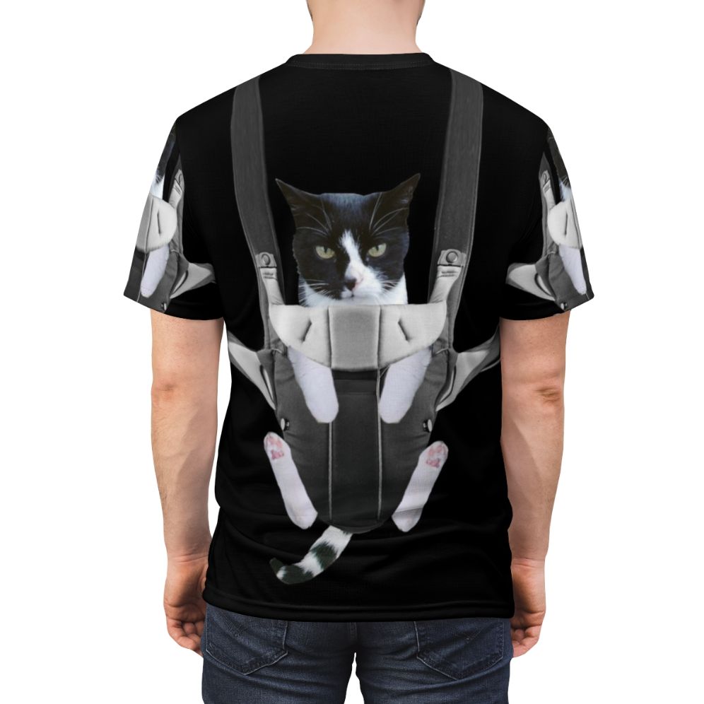 Illustration of a cat snuggled up in a baby carrier on a t-shirt - men back