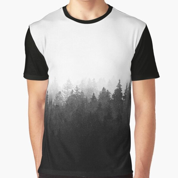 Graphic t-shirt featuring a wilderness landscape with trees, fog, and mountains