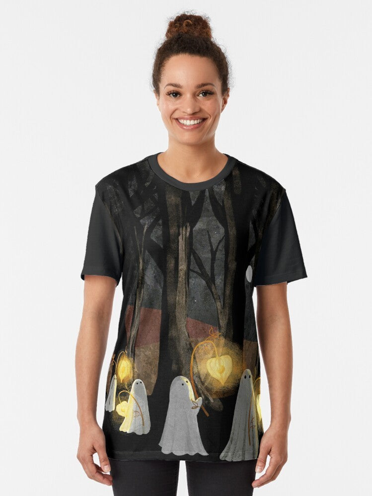 Spooky ghost parade graphic t-shirt with full moon, haunted forest, and glowing lanterns - Women