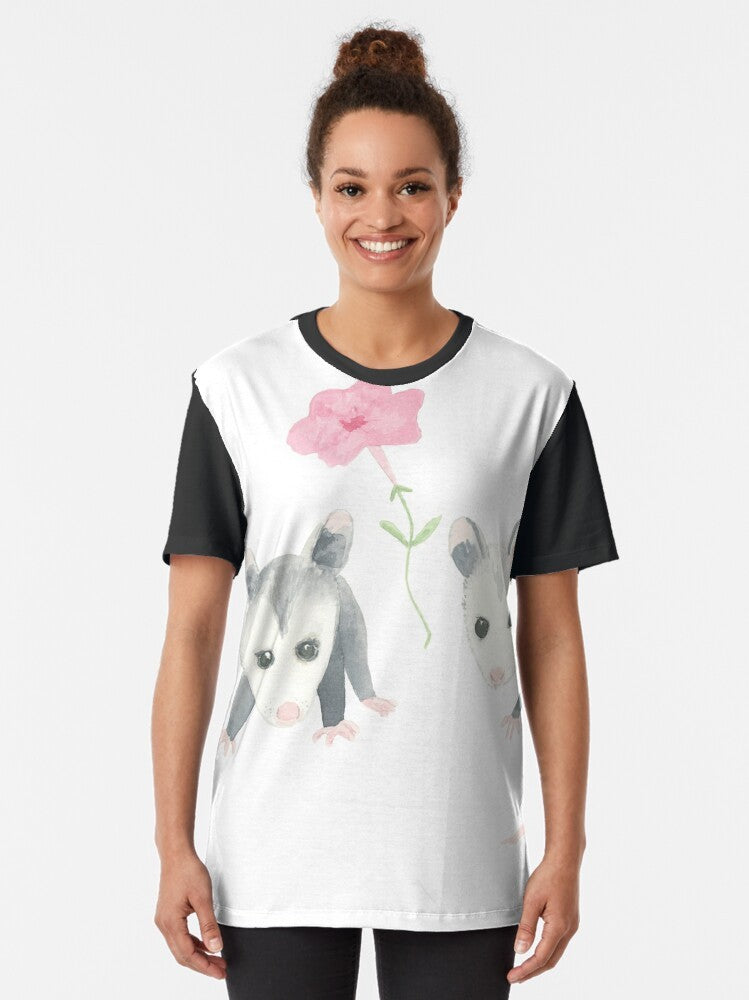 Adorable illustration of a baby opossum surrounded by pink petunias on a graphic t-shirt - Women