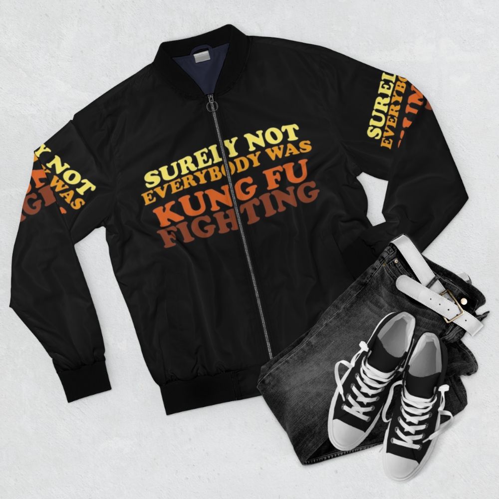 A retro-style bomber jacket with the iconic "Surely Not Everybody Was Kung Fu Fighting" design, featuring martial arts and 70s music references. - Flat lay