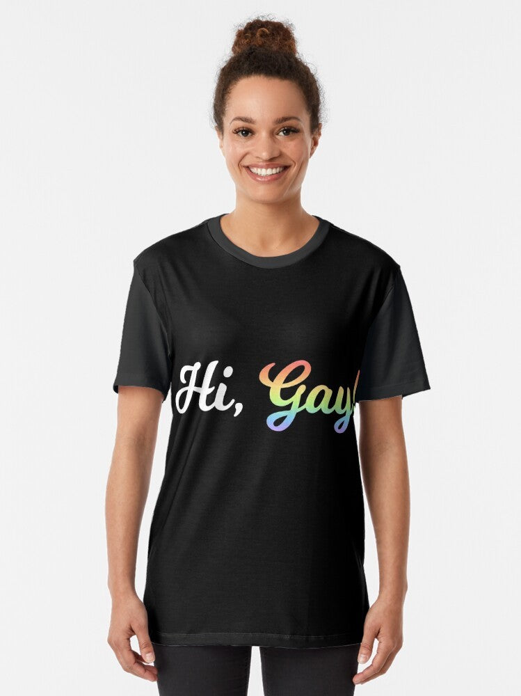 A colorful graphic t-shirt with the text "Hi, Gay!" in a rainbow design. - Women