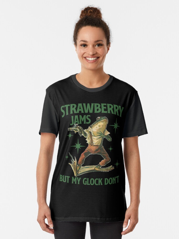 Graphic t-shirt featuring the text "Strawberry Jams But My Glock Don't" on a white background. - Women