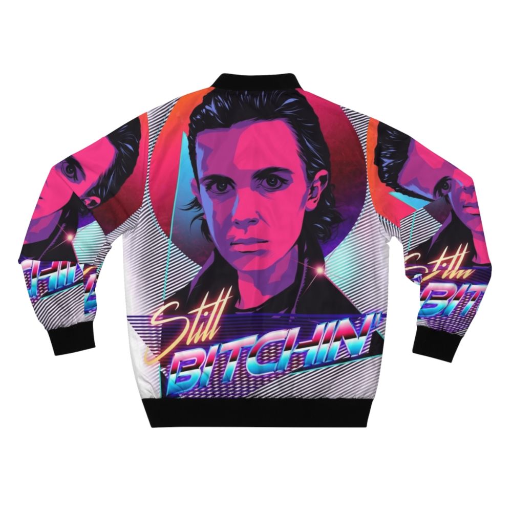 Eleven from Stranger Things wearing a bomber jacket with the text "Eleven is Still Bitchin" - Back