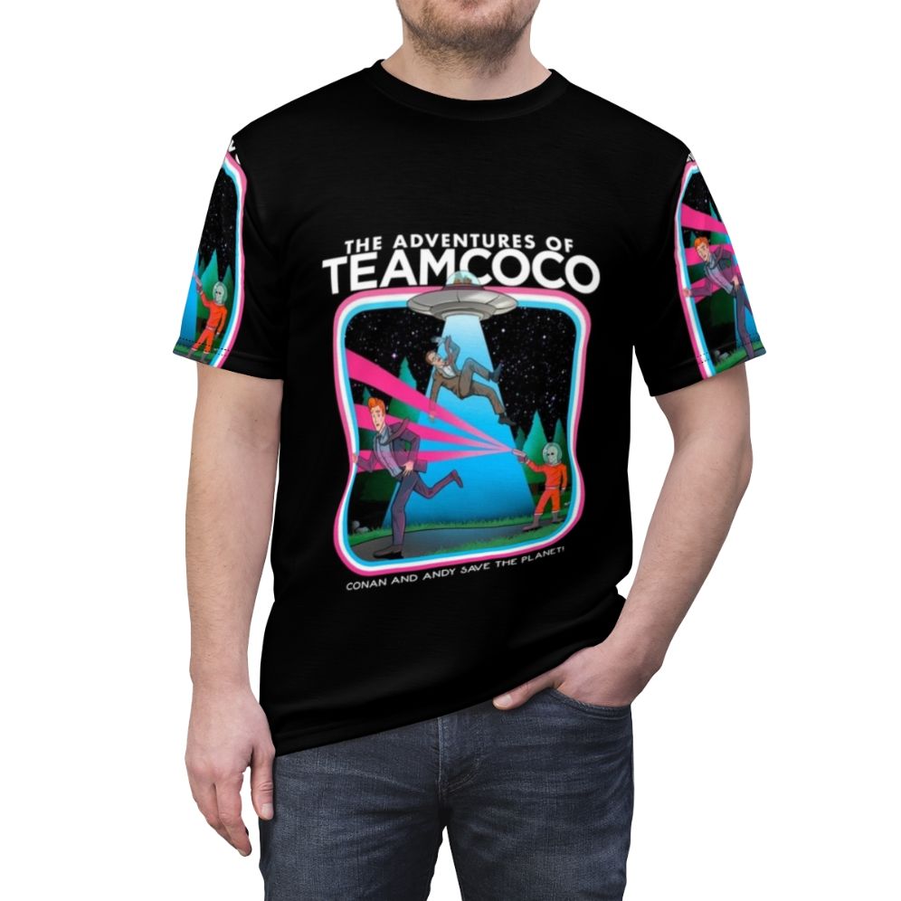 A t-shirt design featuring a comedic alien abduction scene, inspired by the popular Team Coco brand. - men front