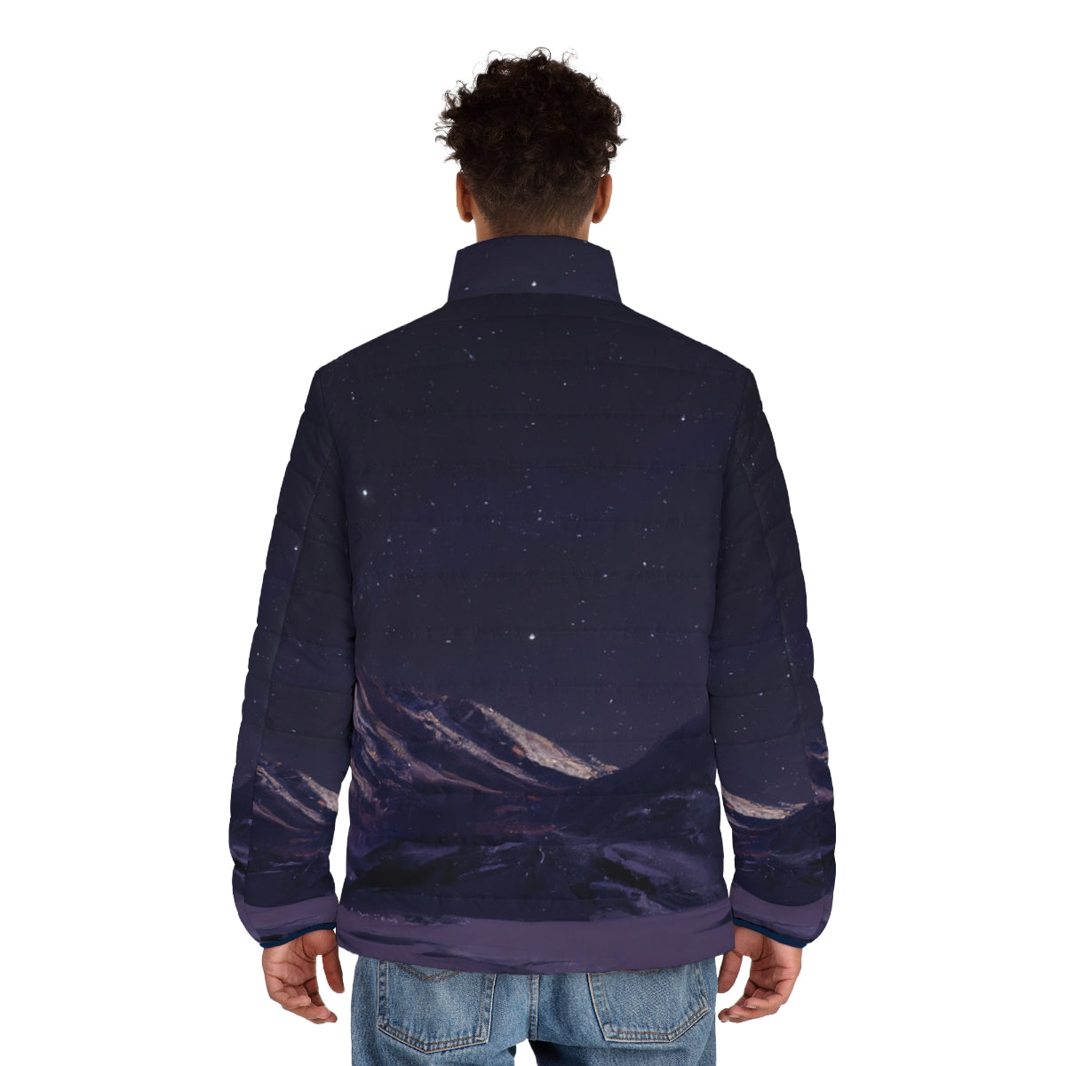 Person wearing a puffer jacket standing in front of a starry night sky and mountains - men back