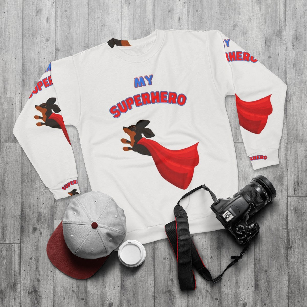 Dachshund wearing a superhero sweatshirt - flat lay