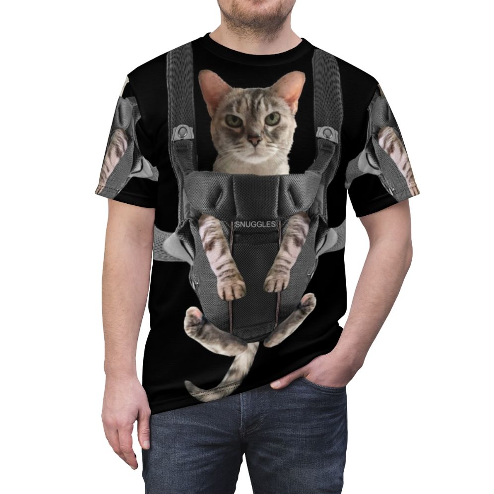 Adorable cat snuggled in a baby carrier on a gray t-shirt - men front