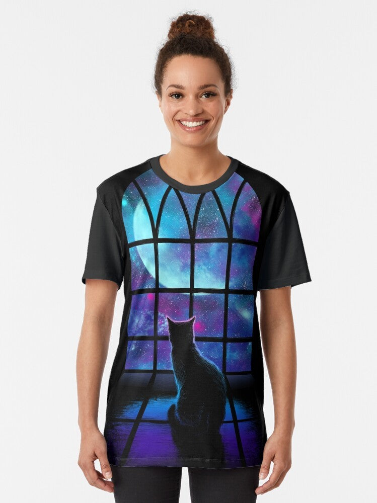 A graphic t-shirt featuring a cute cat in a space-themed design with planets, stars, and the moon. - Women