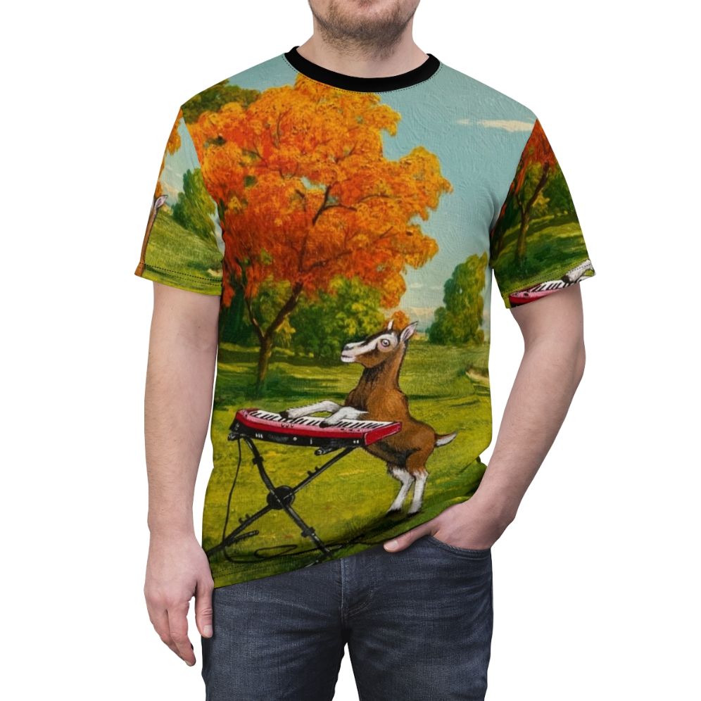 A t-shirt design featuring a goat playing a keyboard in a meadow, with the text "Practicing In The Meadow" - men front