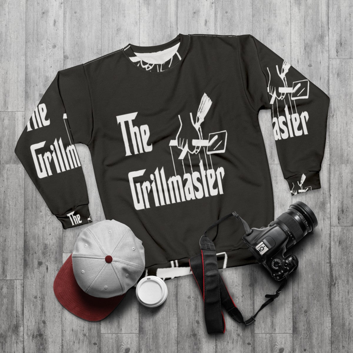 The Grillmaster's Summer Sweatshirt with a funny BBQ and grilling design - flat lay