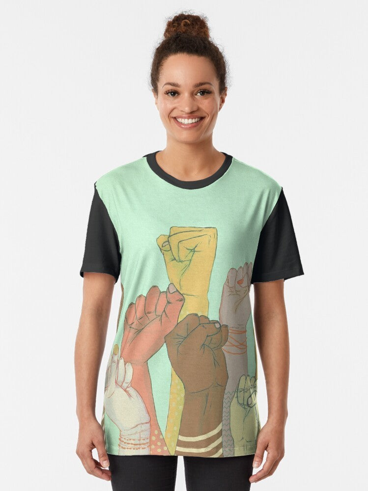 A colorful graphic t-shirt design featuring interlocked hands and arms, symbolizing unity, diversity, and togetherness. - Women