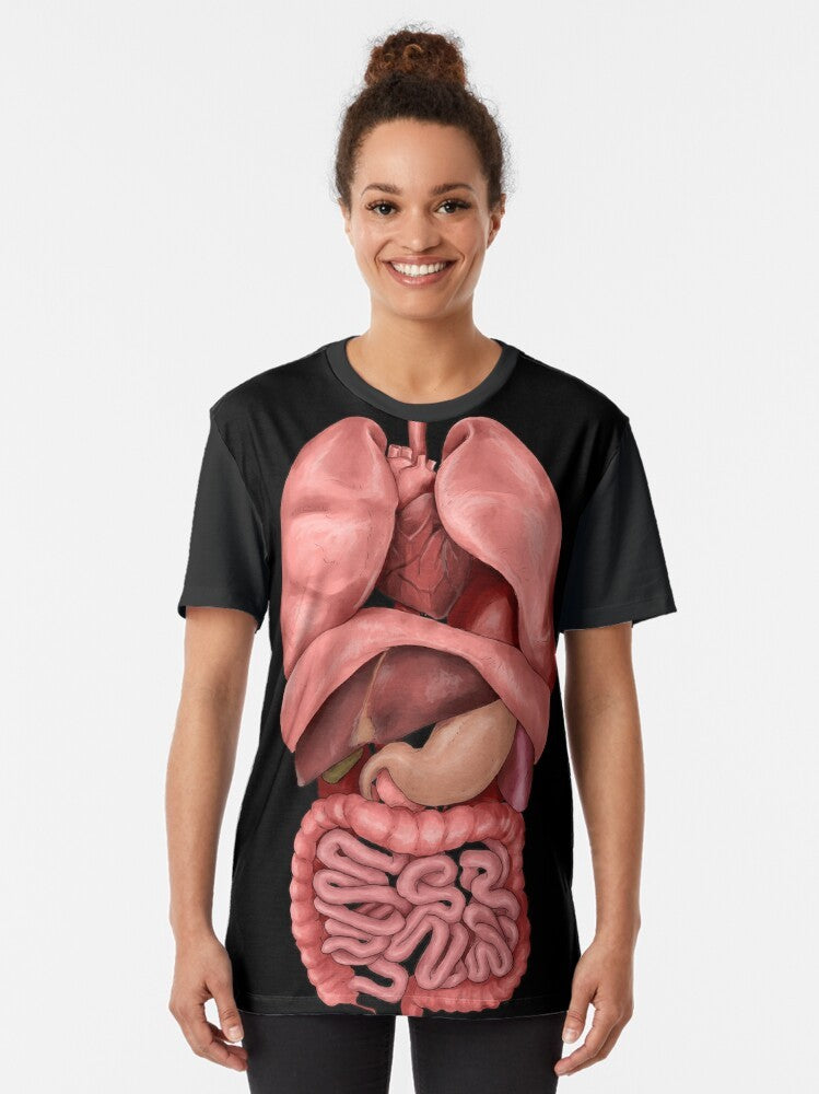 Graphic t-shirt featuring a watercolor-style illustration of the human internal organs, including the heart, lungs, digestive system, and lymphatic system. - Women