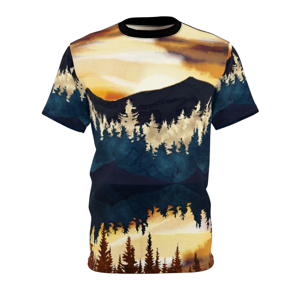 A t-shirt featuring a vibrant, watercolor-style landscape design with a beautiful fall sunset over a lake, surrounded by forests and mountains.