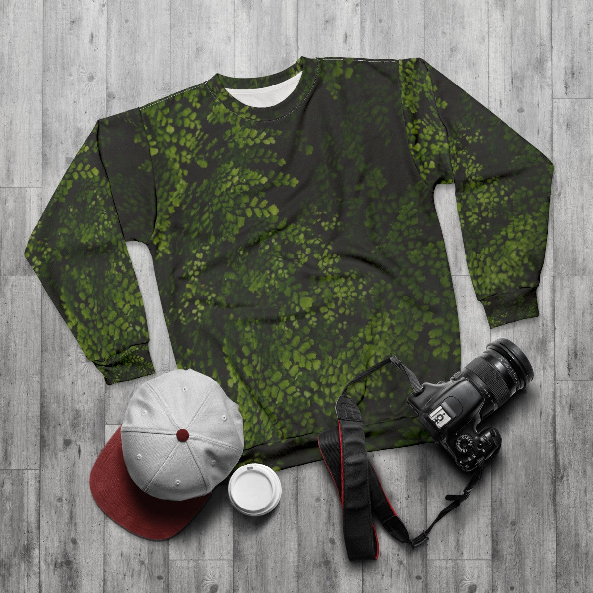 Small tropical leaves sweatshirt with green and botanical design - flat lay