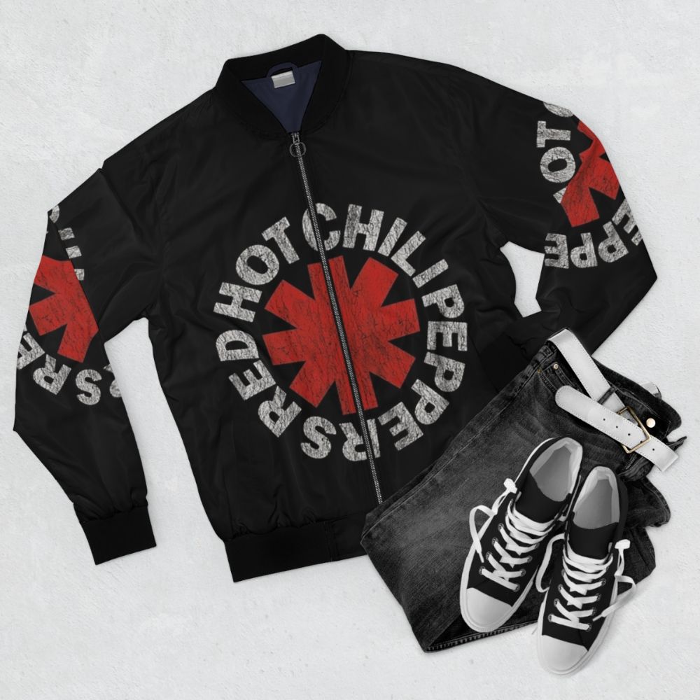 Vintage black bomber jacket with red hot chili peppers and musician inspired graphics - Flat lay