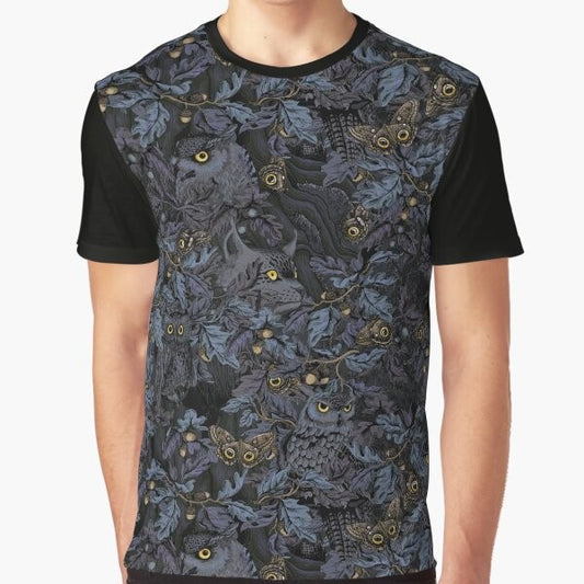 A graphic t-shirt featuring a camouflage pattern with owls, leaves, and moonlight imagery, capturing the beauty of nature's wilderness.