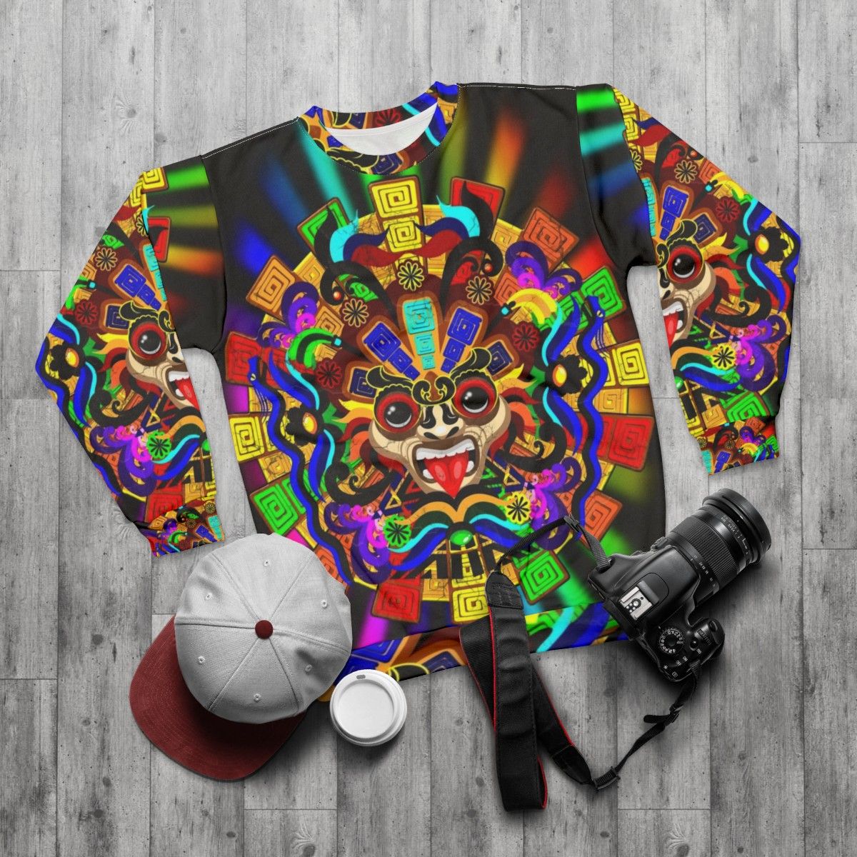 Aztec warrior mask sweatshirt with vibrant rainbow colors - flat lay