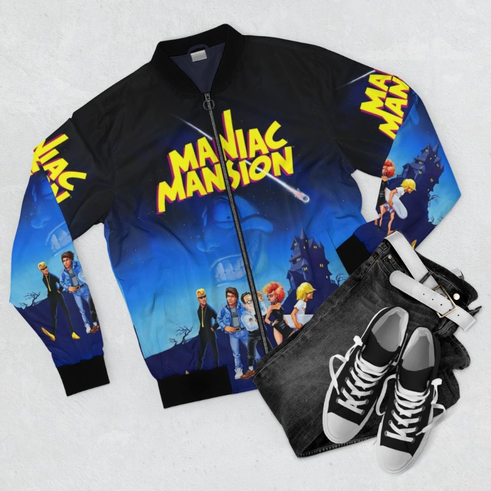 Retro gaming bomber jacket featuring the Maniac Mansion and Day of the Tentacle logos - Flat lay