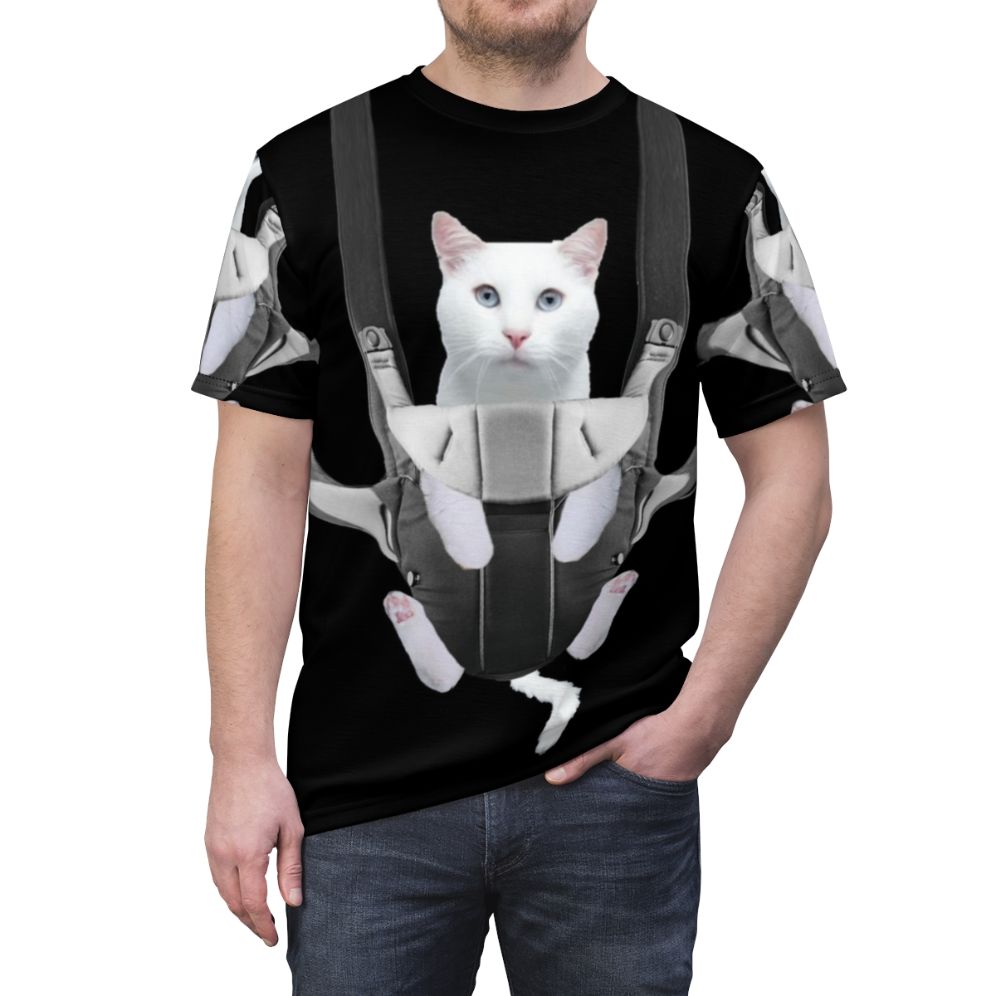 Image of a tabby cat sitting comfortably in a baby carrier against a white background - men front