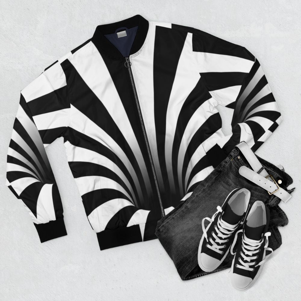 Optical illusion black and white bomber jacket with abstract black hole pattern - Flat lay