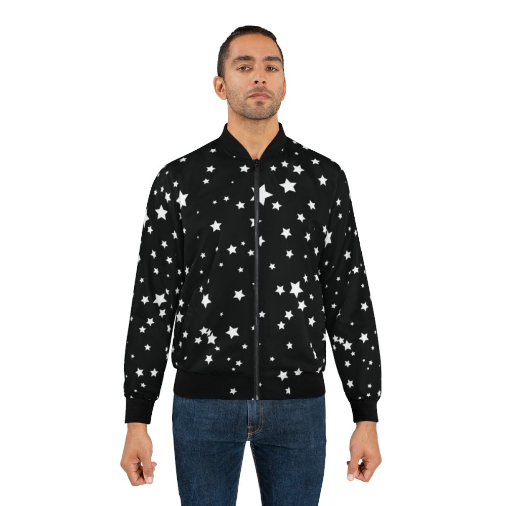 A black and white bomber jacket with a scattered star cluster design, creating a cosmic and spacious aesthetic. - Lifestyle