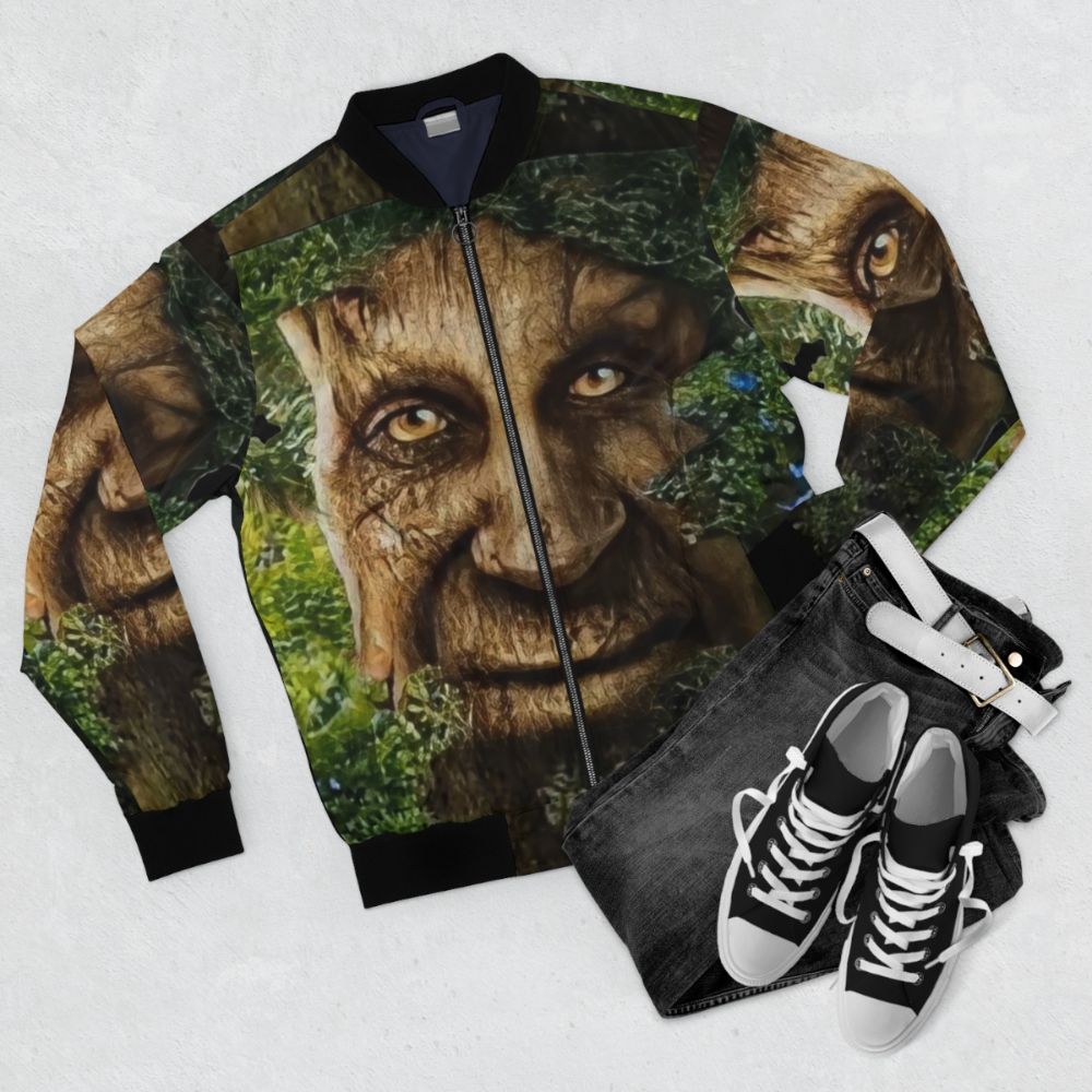 A bomber jacket featuring a graphic design of a wise, mystical tree meme. - Flat lay