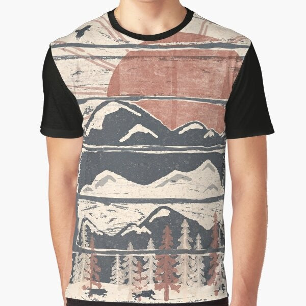 A graphic t-shirt featuring a winter landscape with wildlife such as wolves, hawks, and eagles.